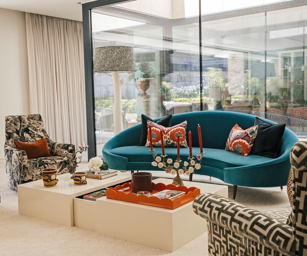Living room with a curved petrol-colored sofa