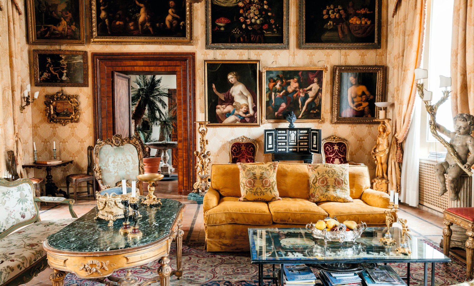 The main salon with Renaissance paintings and ochre damask