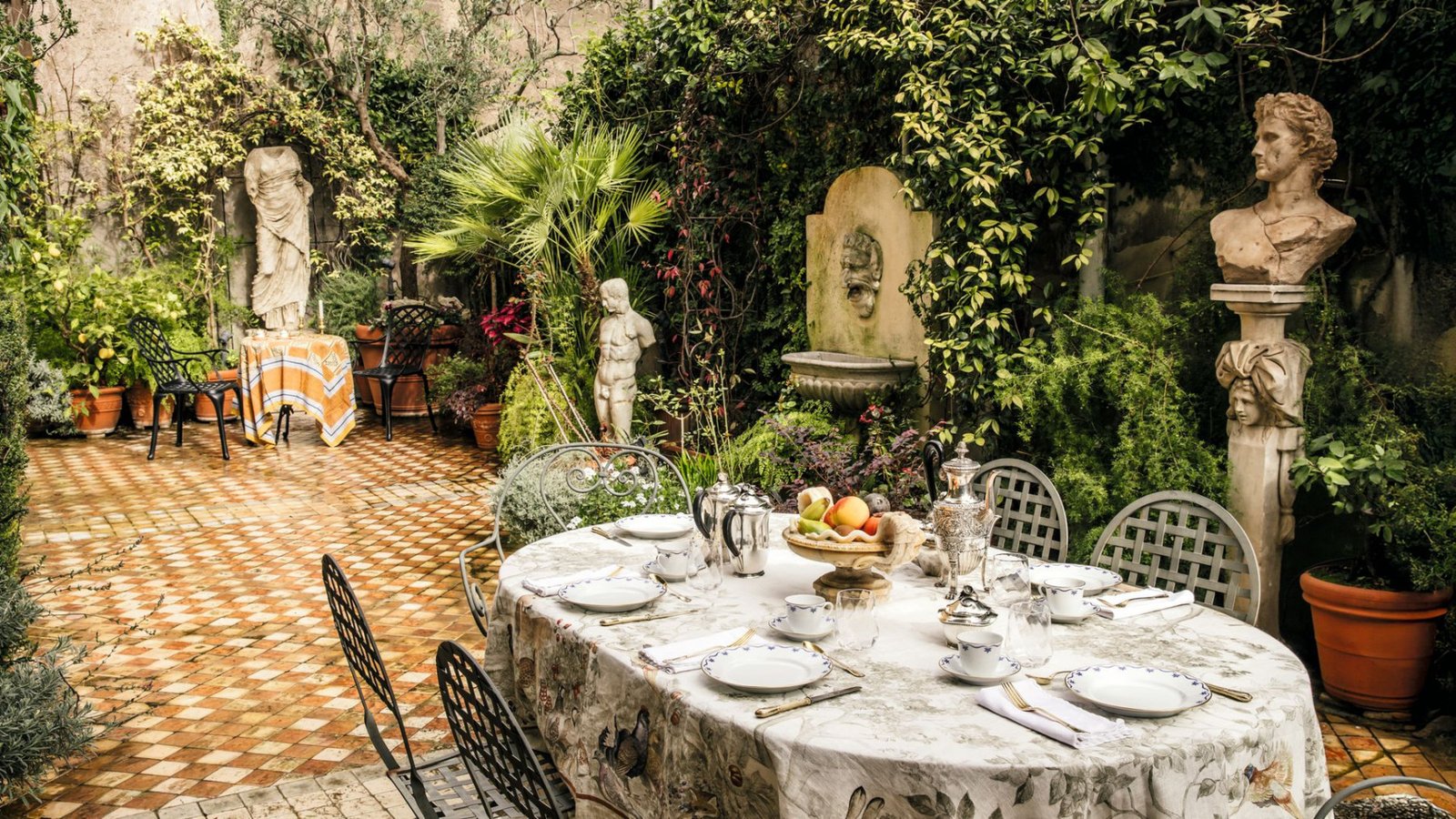The palace terrace with an antique statue and a dining table