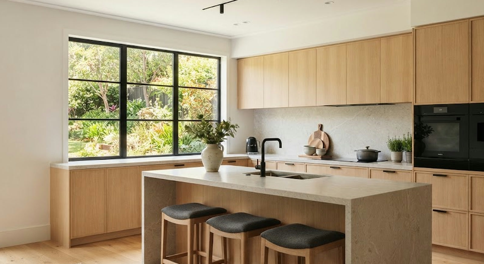 Kitchen in pale wood with a stone island