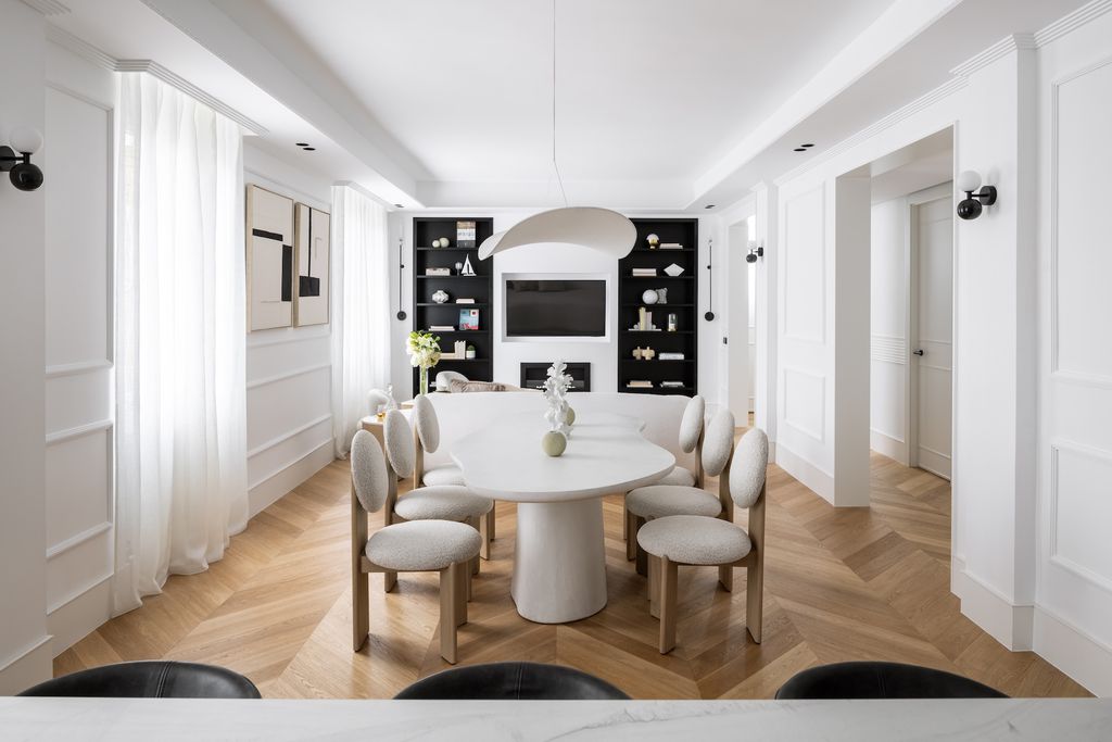 Dining room with white mouldings on the walls and herringbone flooring